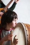 playing on bodhran at a traditional session